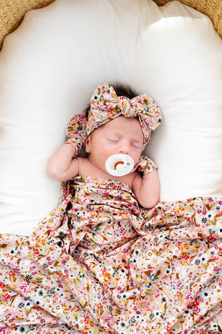 Lou Lou and Company newborn headband bundle with soft swaddle blanket and Penelope headband for baby photography and comfort.