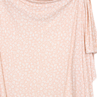 Lou Lou and Company Swaddle Blanket - Louise
A close-up of a draped fabric garment in a light peach-pink color with a small white floral pattern, showing the texture and drape of the material.