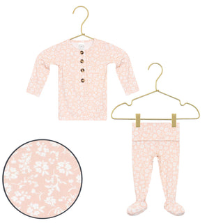 Lou Lou and Company Top and Bottoms - Louise
Baby long-sleeve henley top and matching footed pants set in a light pink and white floral print, shown on hangers with a circular detail inset of the fabric pattern.