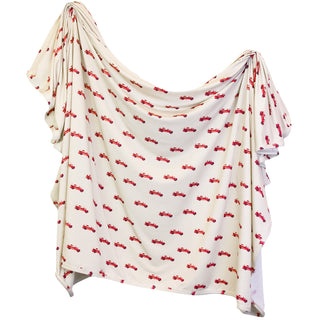 Lou Lou and Company Knit Swaddle Blanket in Marshal with soft, cozy knit fabric, perfect for wrapping a baby.