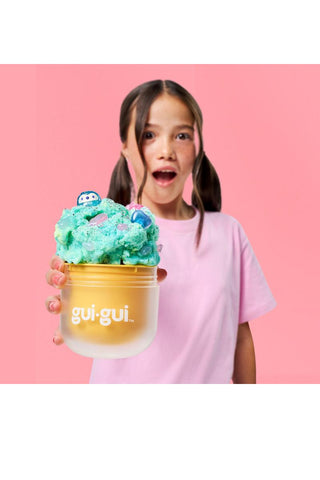 Gui Gui™ Surprise Slime Kit with Mini Figure & Charms
Child holding a colorful ice cream with 'gui-gui' branding against a pink background