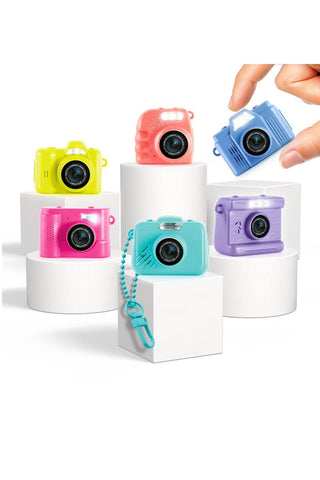 Photo Creator Mini Camera for Kids
Colorful toy cameras on white stands with a hand reaching for one camera.