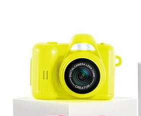 Photo Creator Mini Camera for Kids
Colorful toy cameras on white stands with a hand reaching for one camera.