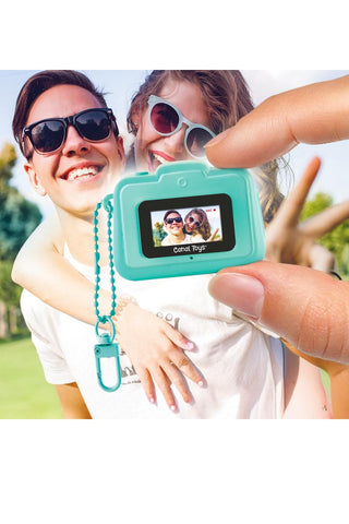 Photo Creator Mini Camera for Kids
Teal digital camera toy held by a person with a child, showing a photo of two people on the screen.