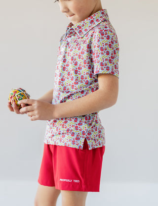 Properly Tied Boys Inlet Polo shirt in classroom setting, featuring a neatly tied collar and classic design for boys' shirts and tops.