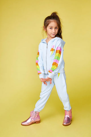 Mini Dreamers Miley Crystal Bolt Zip Up Hoodie and Sweatpant Set 
Young girl in a light blue tracksuit with rainbow details on a yellow background