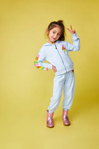 Mini Dreamers Miley Crystal Bolt Zip Up Hoodie and Sweatpant Set
Child wearing a light blue tracksuit with colorful sleeves on a yellow background