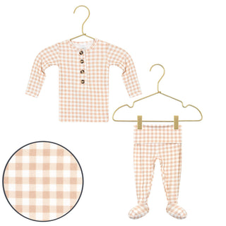 Lou Lou and Company Top and Bottoms - Milo
Baby long-sleeve henley top and footed pajama pants set in a peach and white gingham check pattern, shown on hangers with a circular detail inset of the fabric pattern.