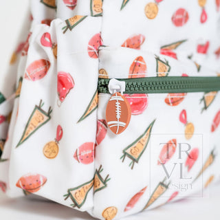 TRVL Designs Mini Backer - Touchdown
Fabric with sports-themed pattern featuring footballs, cones, and other elements, with a zipper visible.