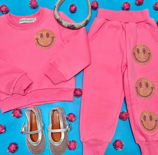 Mini Dreamers Naomi Crystal Smiley Face Sweatshirt and Sweatpant Set
Pink outfit with smiley face designs on a blue background