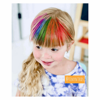 Hair Coloring Chalk - 12 Pack Set
Child with colorful hair extensions and a visible brand logo.