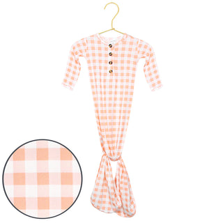Peach gingham Lou Lou and Company Evie knotted gown for babies, featuring a soft fabric and stylish design.