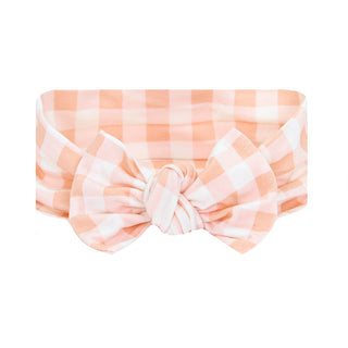 Peach gingham Lou Lou and Company Evie headband with bow for girls, featuring soft fabric and stylish design.