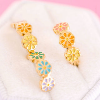 Pierced Co. Colorful Daisy Huggies
Colorful floral earrings on a white and pink gradient background
