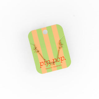 Pip Pop Post Bow Repeat Necklace
Gold necklace on a striped green and orange card with 'pip pop' branding.