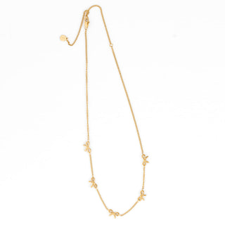 Pip Pop Post Bow Repeat Necklace
Gold necklace with star-shaped pendants on a white background