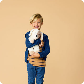 Puppy Warmies
Child holding a teddy bear against a beige background