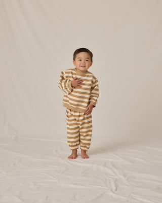 Quincy Mae Oversized Crew Sweatshirt & Oversized Sweatpant Set - Gold Stripe
Child wearing a striped outfit on a plain background