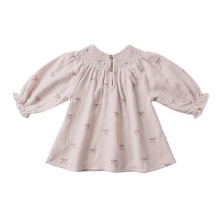 Quincy Mae V Smocked Dress - Bows
Pink dress with bow pattern on a white background