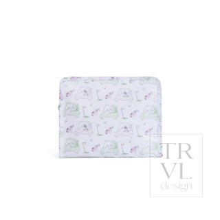 TRVL Designs Roadie Large Zip Pouch - Putt Putt Pink
A small zippered wallet with a white background and a repeating golf-themed pattern featuring golf carts, golf balls, clubs, and golfers in soft pastel colors. A faint 'TRVL design' watermark is visible on the right side.