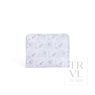 TRVL Designs Roadie Medium Zip Pouch - Putt Putt Pink
A rectangular zippered pouch or wallet with a white background and a repeating golf-themed pattern featuring golf carts, clubs, and golf balls in pastel pink, green, and purple. A faint 'TRVL design' watermark is visible on the right side.