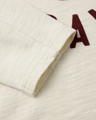 Rylee & Cru Long Sleeve Paneled Tee - Game Day
Close-up of a textured fabric with a brand logo on a white background