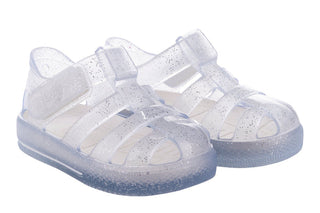 Igor Star Glitter Gloss in Transparente Glitter
Clear jelly sandals with straps on a white background