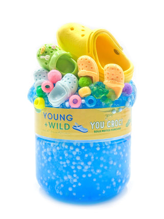 Bright green slime titled "You Croc My World" by Young Wild and Friedman, with a textured, glossy appearance in the image.