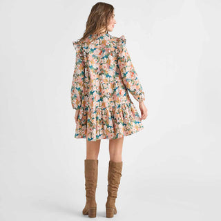 Pink Chicken Womens Kalani Dress - Watercolor Floral Woman wearing a floral dress with long sleeves and brown knee-high boots on a white background
