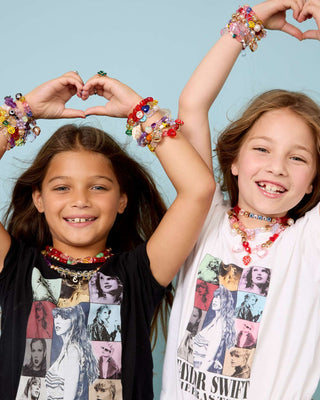 Super Smalls Super Entrepreneur Bead Kit Two children wearing colorful jewelry against a light blue background