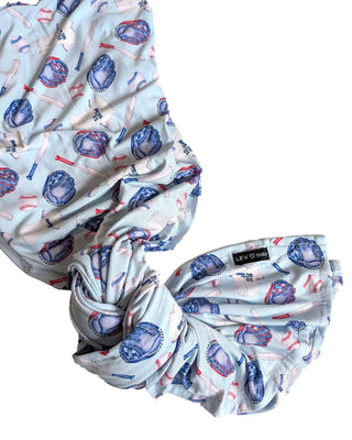 Lev Baby Swaddle in Home Run design, soft and cozy fabric, perfect for soothing and wrapping infants securely.