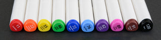 The Pencil Grip Inc Air Colors Airbrush Kit 
Set of colorful markers arranged in a row on a dark background