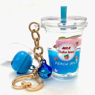 BCMINI Peach Milk Bell Charm Keyring featuring a cute peach milk design and a small bell, attached to a metal keychain.
