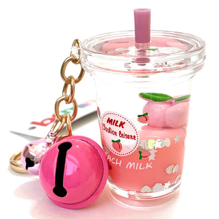 BCMINI Peach Milk Bell Charm Keychain featuring a whimsical peach milk design and a small bell attachment.