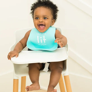 Bella Tunno Lit in Little Wonder bib with colorful patterns and adjustable neck strap on soft fabric.