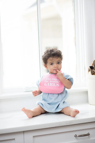 Bella Tunno Who Runs the World Wonder Bib with colorful design, soft fabric, and adjustable neck for babies and toddlers.