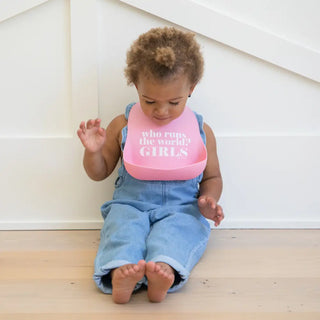 Bella Tunno Who Runs the World Wonder Bib with colorful design, soft fabric, and secure fastening for toddlers' mealtime protection.