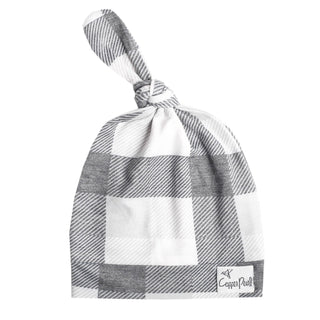 Copper Pearl Hudson top knot hat in soft copper color, featuring a cozy knit design and a stylish top knot detail.
