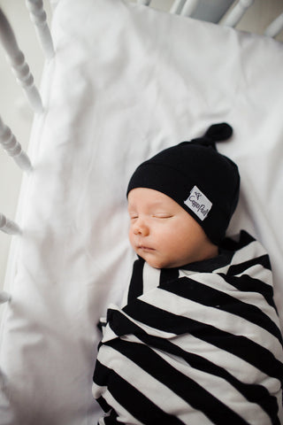 Copper Pearl Midnight Top Knot Hat, soft baby hat with a cute top knot, made of cozy fabric for infants and toddlers.
