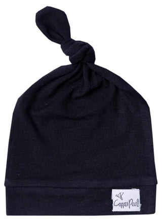Copper Pearl Midnight Top Knot Hat, a soft baby hat with a stylish top knot in dark navy, designed for comfort and warmth.