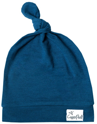 Copper Pearl River Top Knot Hat in soft fabric with a stylish knot detail, designed for comfort and warmth for babies.