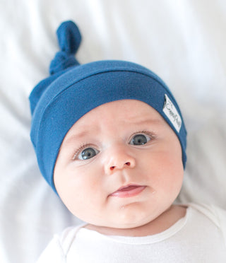 Copper Pearl River Top Knot Hat in soft fabric with a stylish top knot, designed for babies and toddlers.