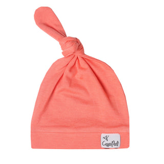 Copper Pearl Stella top knot hat in soft fabric, featuring a stylish knot on the front, designed for comfort and warmth.