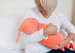Copper Pearl Stella top knot hat in copper color, soft knit baby hat with a stylish knot detail designed for comfort and warmth.