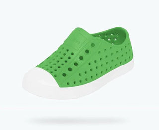 Native Jefferson shoes in grasshopper green and shell white, featuring durable design and casual style, shown in a side view.