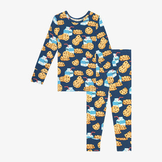 Baby girl wearing Posh Peanut Milk & Cookies long-sleeve pajama set in soft fabric, featuring playful cookie and milk print.