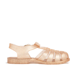 Shooshoos Jelly Sandal Cali in gold glitter, side view showing the sparkly, flexible jelly material and stylish design.