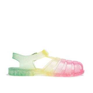 Shooshoos Jelly Sandal in rainbow glitter for girls, showing the right side with colorful, shiny jelly material and strap details.