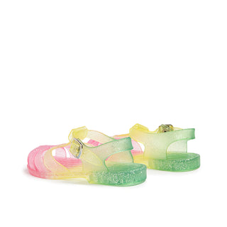 Shooshoos Jelly Sandal in rainbow glitter, right foot view, back side showing colorful, sparkly jelly material and sandal straps.