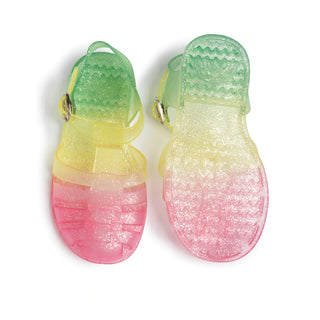 Shooshoos Jelly Sandal in rainbow glitter for girls, showing the right shoe with colorful, sparkly jelly material and open toe design.
